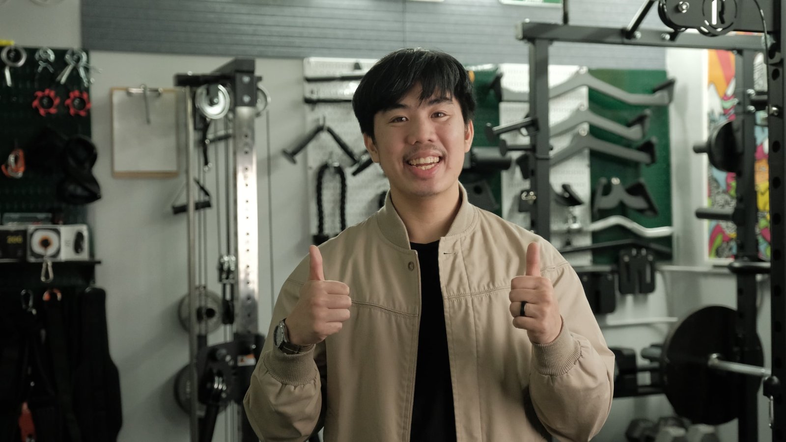 Frugal Home Gym creator giving a thumbs up in a home gym